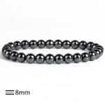 Black hematite bead bracelet with glossy 8mm beads, laid in a circular loop.
