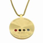 Gold circular pendant on a chain with four colored dots and engravings 'SCALAR ENERGY' and 'JAPAN TECHNOLOGY', code SE 24172