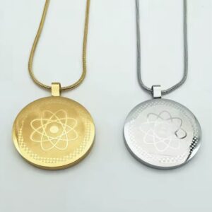 Gold and silver round atom pendants on matching chain necklaces (one gold, one silver).