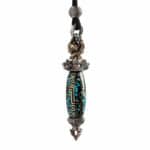 Ornate pendant necklace with a turquoise-inlaid bead and silver filigree caps on a black cord strap.