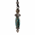 Ornate pendant necklace with a turquoise-inlaid bead and silver filigree caps on a black cord strap.